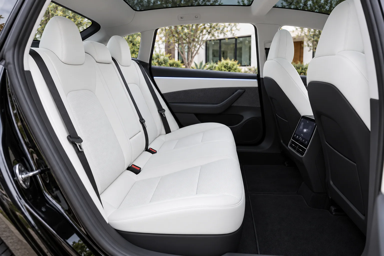 Warm ivory rear seating inside the black fastback