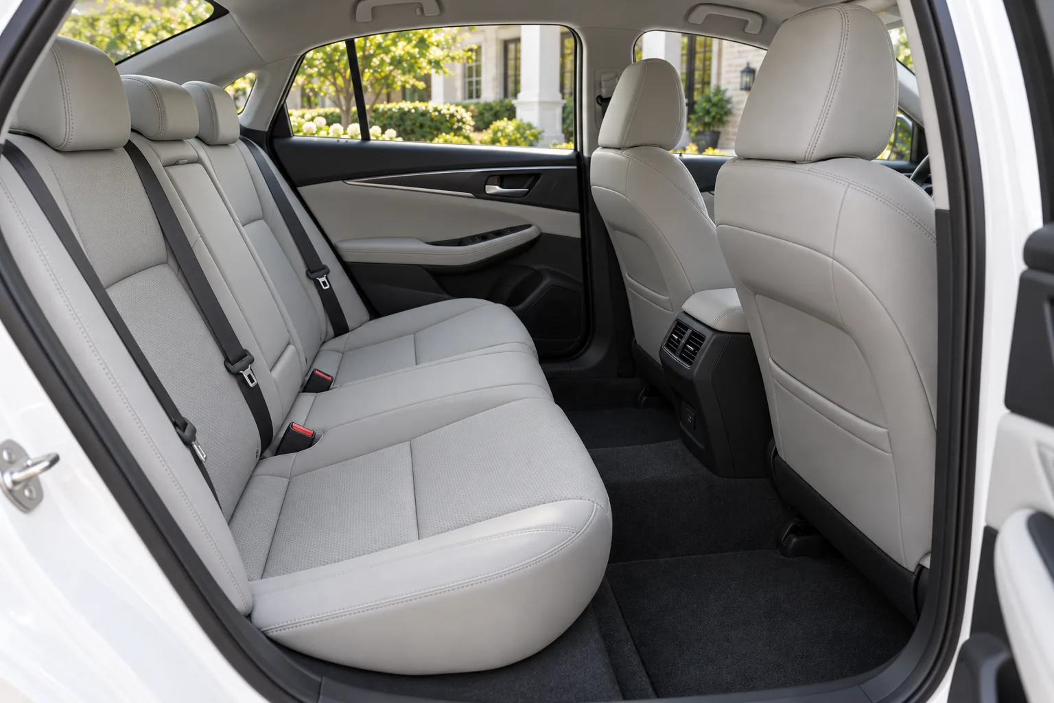 Gray rear seating in the pearl-white daily sedan
