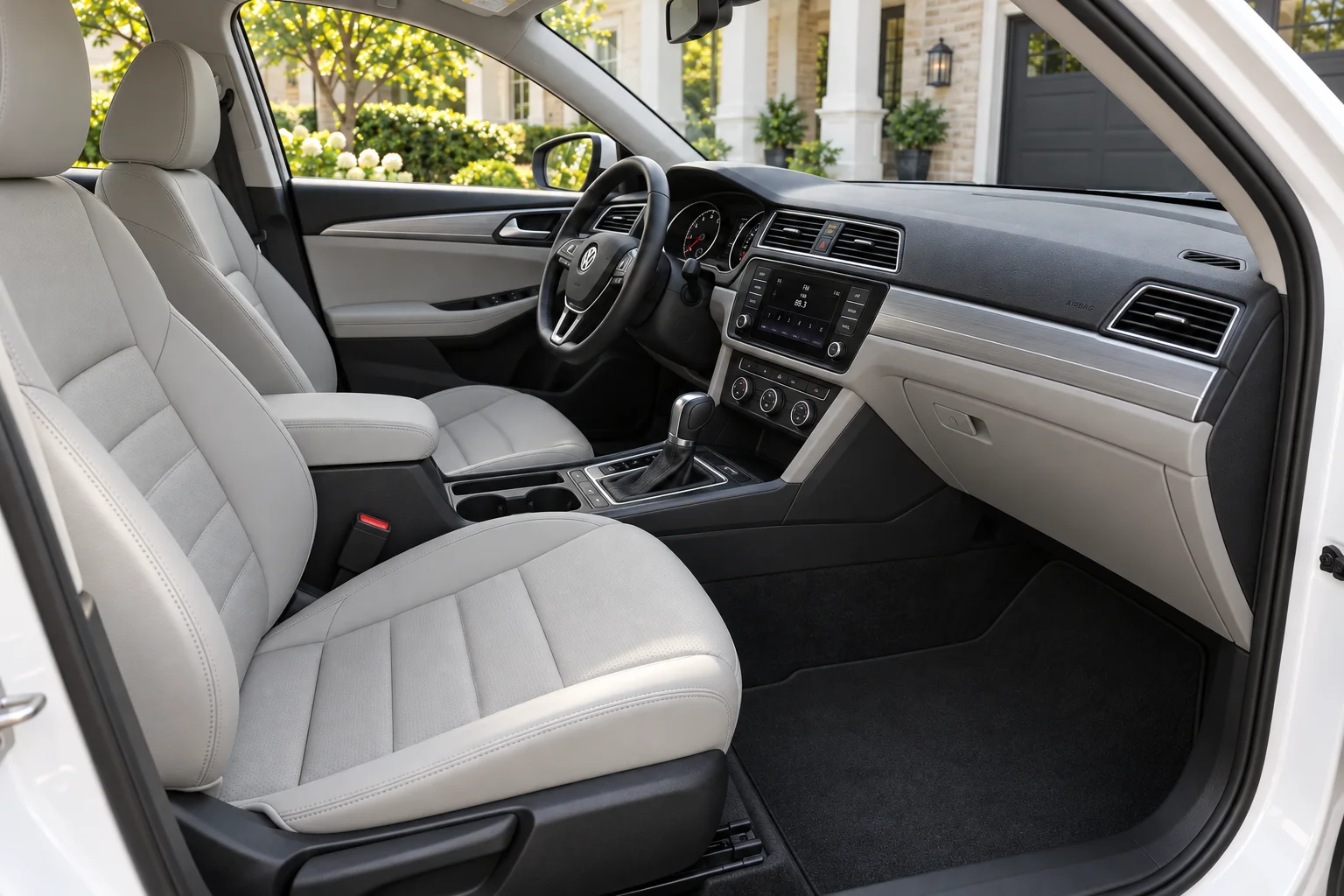 Gray leatherette front cabin of the pearl-white sedan